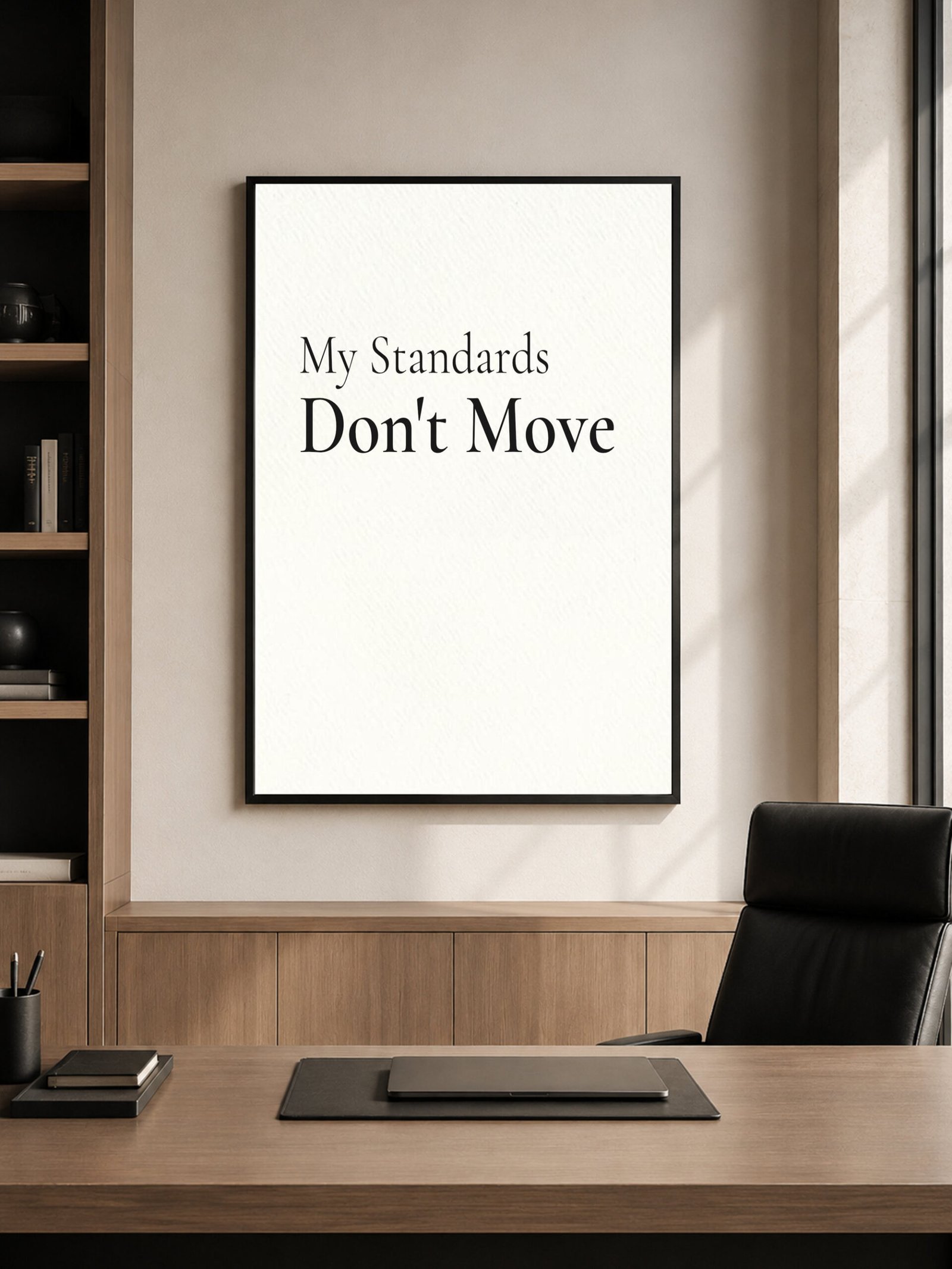 My Standards Don't Move print above a minimalist desk